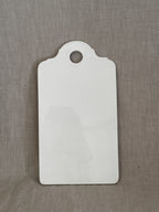 Antique white faience board with moulded rococo shell relief and hanging hole, glazed front, on linen