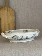 Low oval Rörstrand Papaver footed bowl with leaf-scroll handles, seen from the side on linen