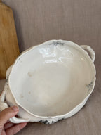 Inside of the Rörstrand Papaver bowl held in a hand, showing the crazed cream glaze and rim sprigs