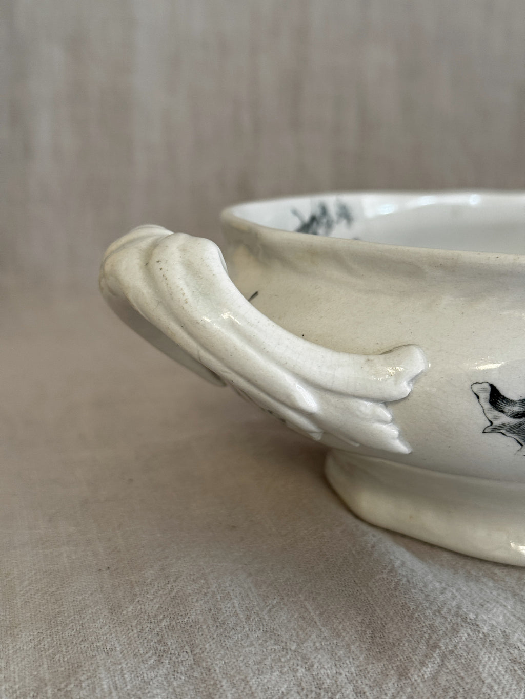 Detail of the moulded leaf-scroll handle and foot ring on the Rörstrand Papaver bowl