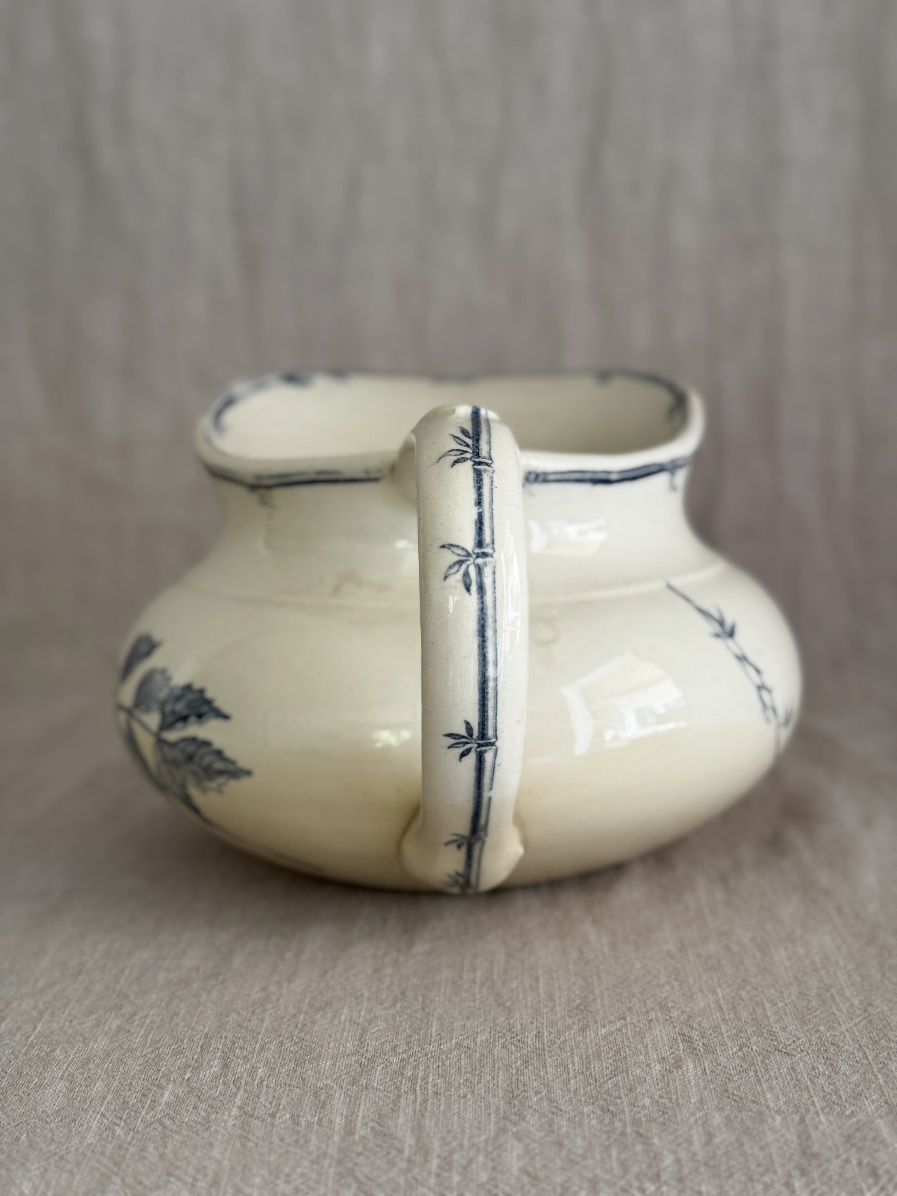 Back view of the jug with the bamboo-moulded handle hand-painted with dark blue nodes and small leaves