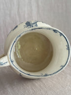 Looking down into the jug showing the honey-toned interior glaze and the bamboo border painted around the inner rim