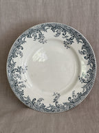 Overhead view of the compotier with the wide rim filled with blue-grey rococo scrollwork, roses and bellflowers