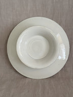 Underside of the compotier showing the plain cream-glazed pedestal foot with fine crazing and no maker's mark