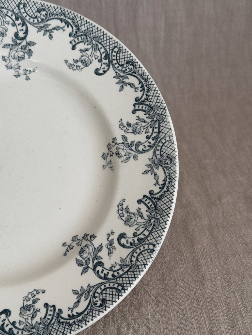 Detail of the transfer border with printed roses, ribboned scrolls and cross-hatched lattice on cream glaze