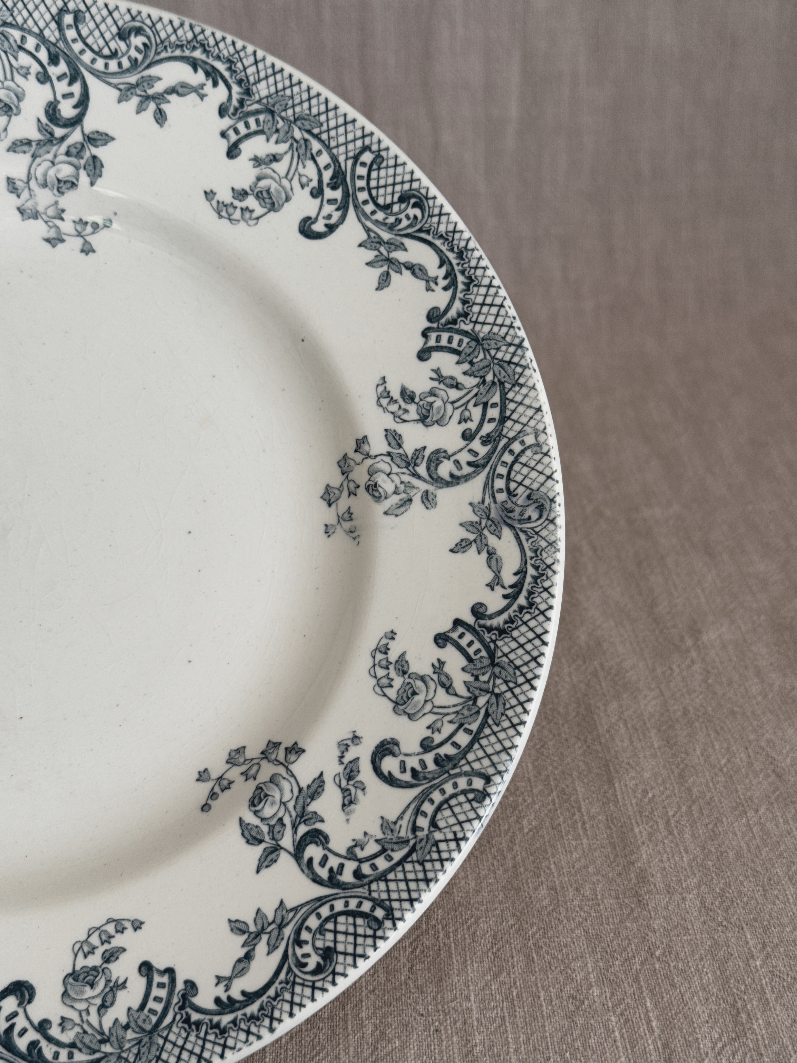 Detail of the transfer border with printed roses, ribboned scrolls and cross-hatched lattice on cream glaze