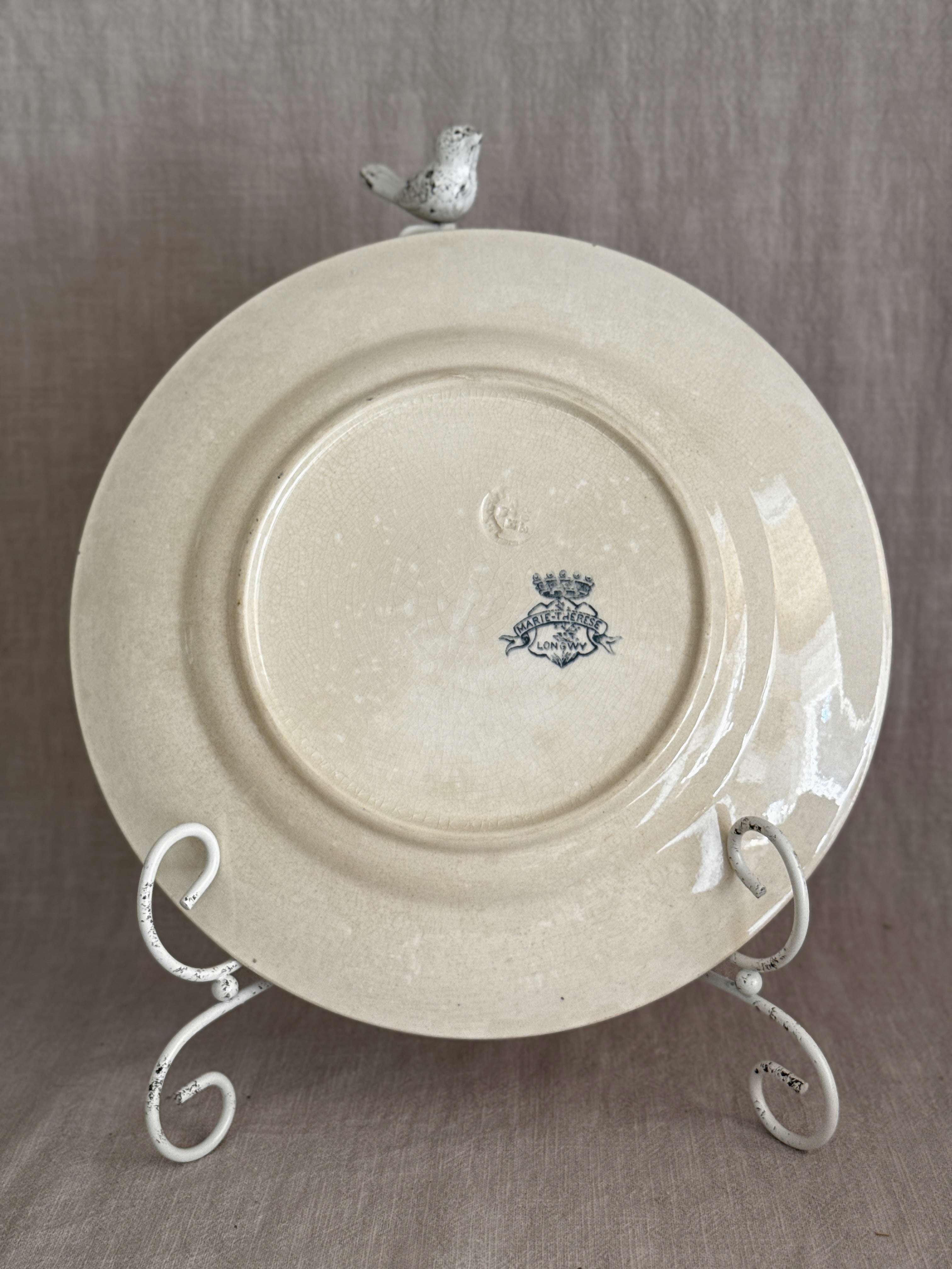 Back of the second plate showing the same Longwy mark, with heavier crazing and an impressed factory stamp above it