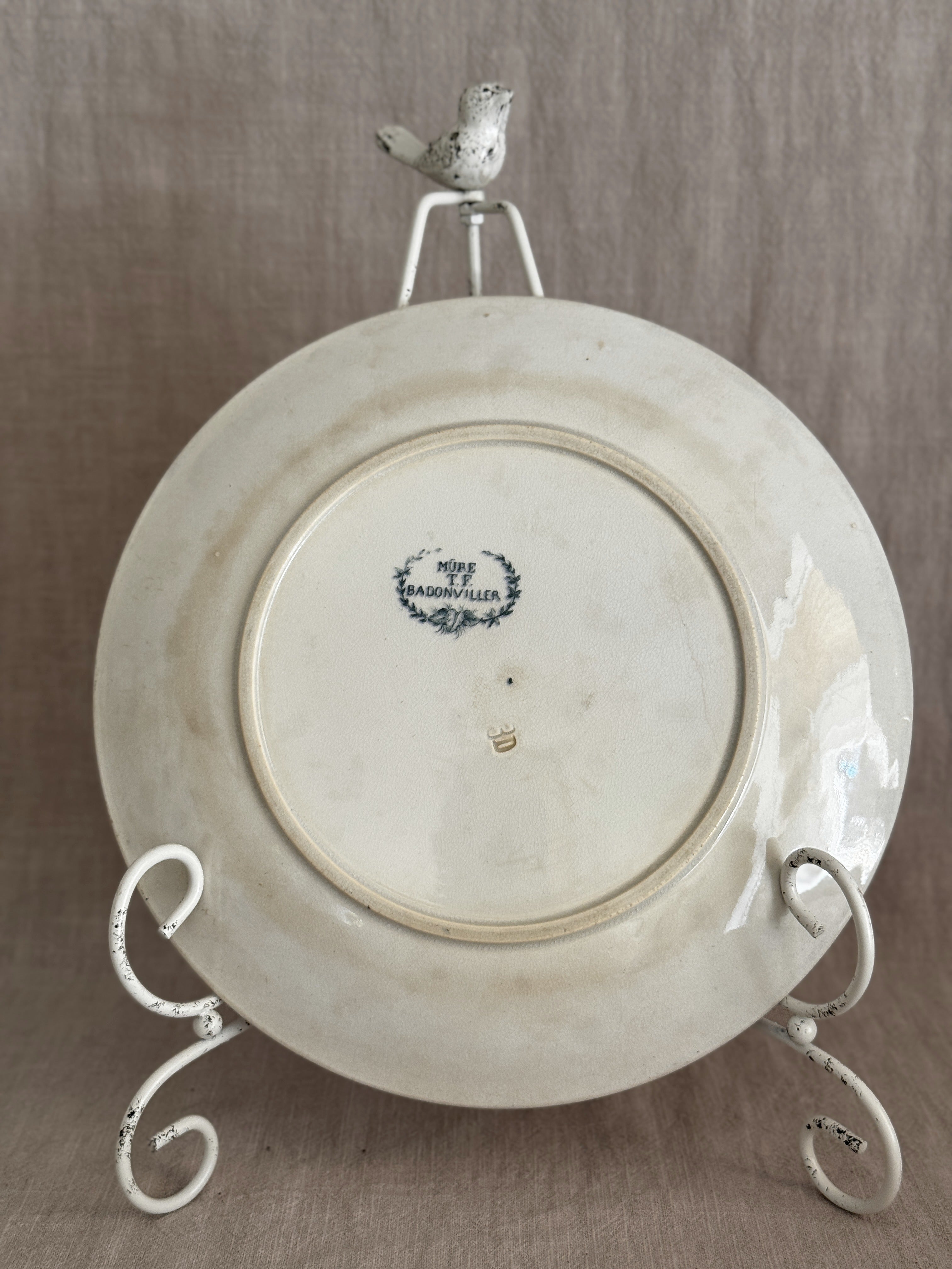 Reverse of the plate showing the blue Badonviller backstamp reading MURE, T.F., BADONVILLER inside a laurel wreath