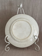 Reverse of an unmarked cream terre de fer luncheon plate showing the foot ring, fine glaze crazing and an impressed 4M mould number