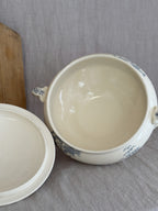Interior of the antique French terre de fer tureen in warm ivory, with the lid resting alongside