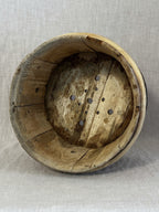 Interior of the antique Swedish cheese mould, scrubbed pale wood with a pierced base for draining