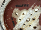 Close-up of the J. W. STURE stamp and drainage holes on the base of the antique Swedish cheese mould