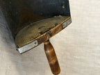 Detail of the grain scoop's wooden back plate with iron straps and the turned wooden handle